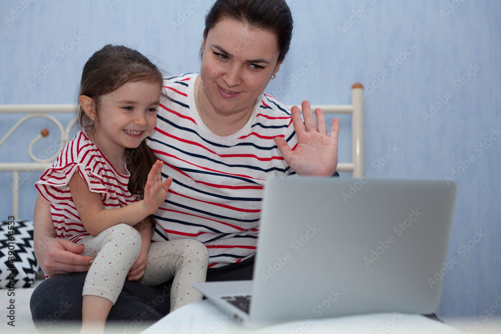 Mom and daughter communicate on a laptop. Online communication. Congratulations on the Internet. Mom and daughter communicate on a laptop. Online communication. Congratulations on the Internet.