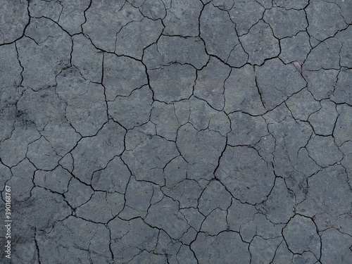 Dry Gray ground covered with crackles . Rusted Background. 