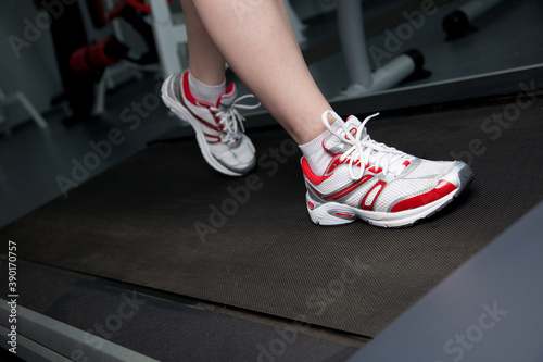 person running on treadmill © MariyaL