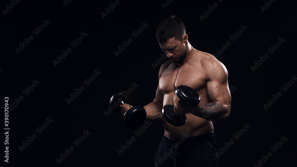 Fit and sporty bodybuilder over black background. Sportsman in studio. Sport and fitness concepts.