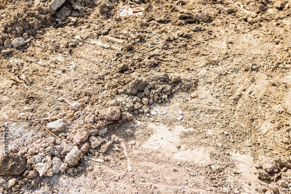 Hard soil with stone from the construction site, environmental and nature concept background, outdoor day light Hard soil with stone from the construction site, environmental and nature concept background, outdoor day light