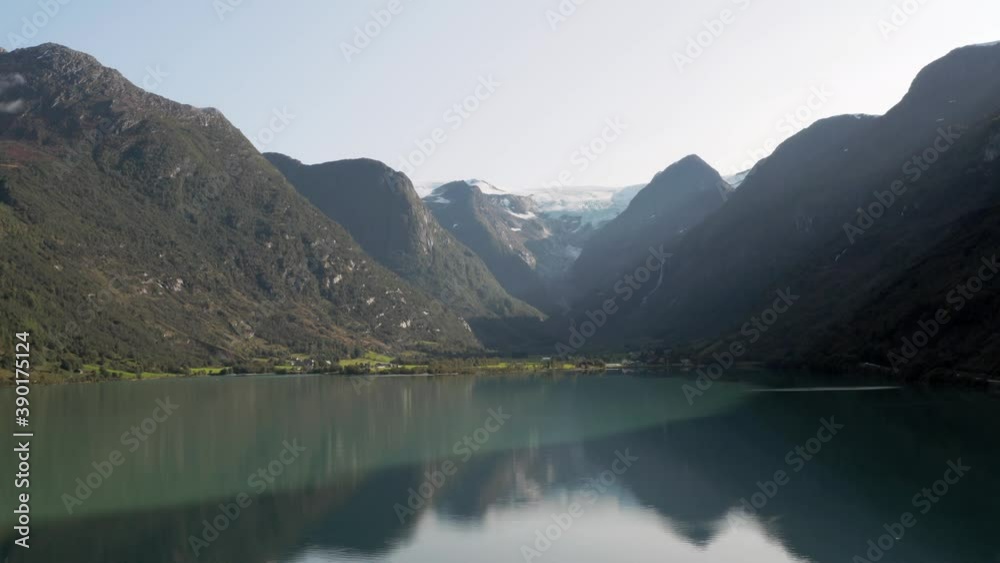 Aerial View of Glacial Lake Under Norwegian Mountains and Glacier on Summer Day. Oldevatnet, Norway, Drone Shot Aerial View of Glacial Lake Under Norwegian Mountains and Glacier on Summer Day. Oldevatnet, Norway, Drone Shot