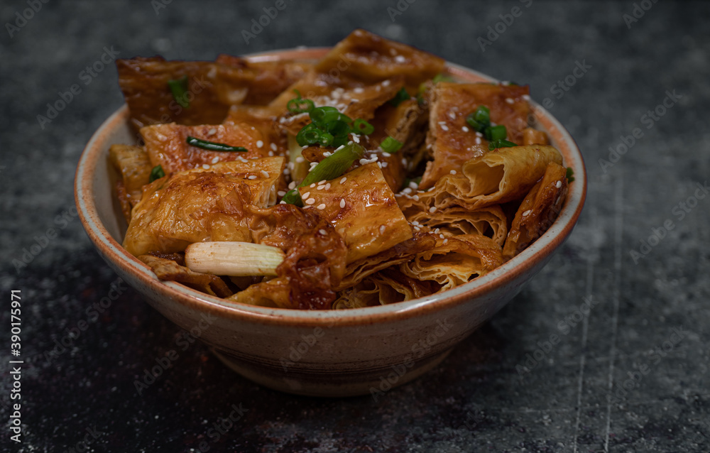 Japanese vegan teriyaki yuba tofu skins in bowl Japanese vegan teriyaki yuba tofu skins in bowl