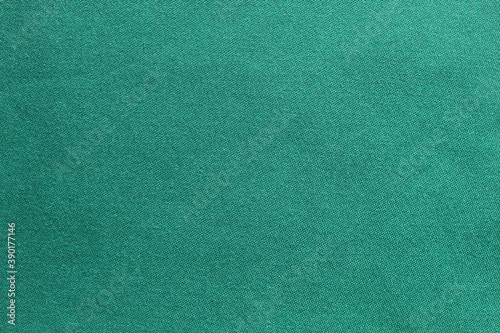Green background with fabric texture is suitable for new year and Christmas compositions