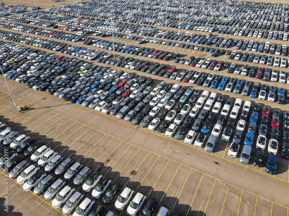 Obraz premium Aerial shot of parked cars in a structured row parking lease cars new production industry