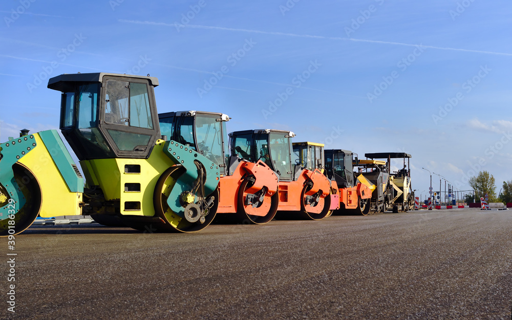 road construction and asphalt compaction with yellow road rollers. Parking lot of road rollers in a row road construction and asphalt compaction with yellow road rollers. Parking lot of road rollers in a row