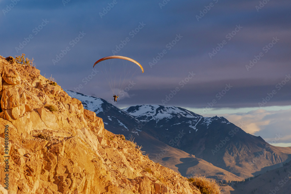 Paragliding against snow-capped Andes mountains during winter season in Esquel, Patagonia, Argentina Paragliding against snow-capped Andes mountains during winter season in Esquel, Patagonia, Argentina