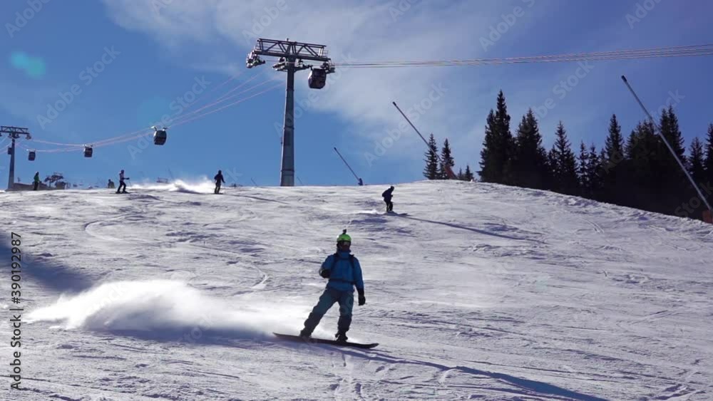 Snowboarder Goes Down the Ski Slope With Snow Dust. Slow Motion Snowboarder Goes Down the Ski Slope With Snow Dust. Slow Motion