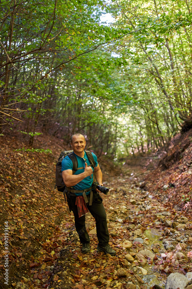 Nature photographer hiking into the forest Nature photographer hiking into the forest