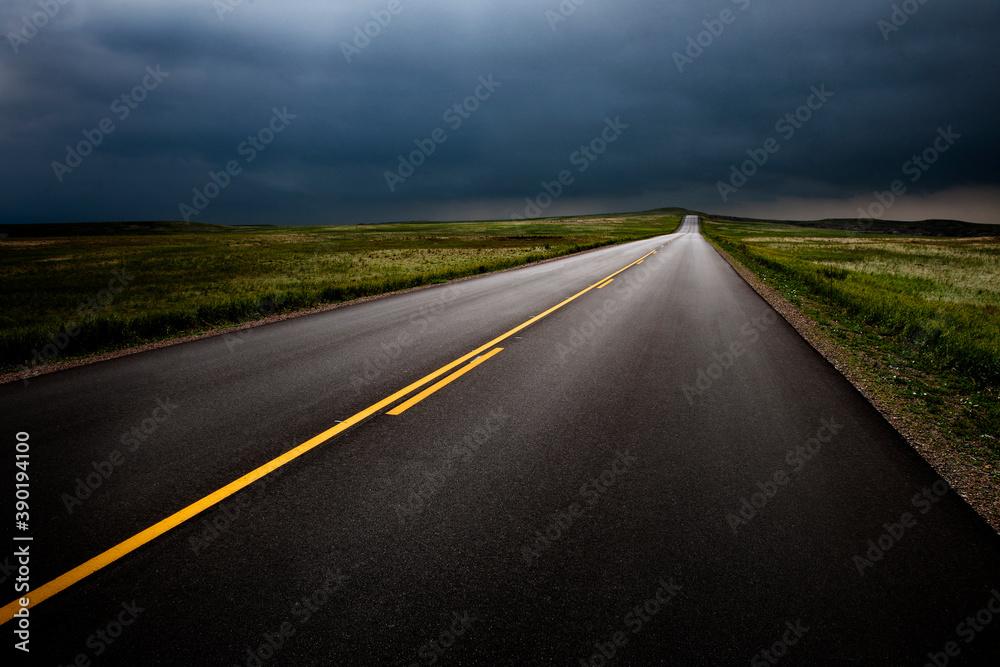 USA, South Dakota, Badlands National Park, Storm clouds over road in prairie USA, South Dakota, Badlands National Park, Storm clouds over road in prairie