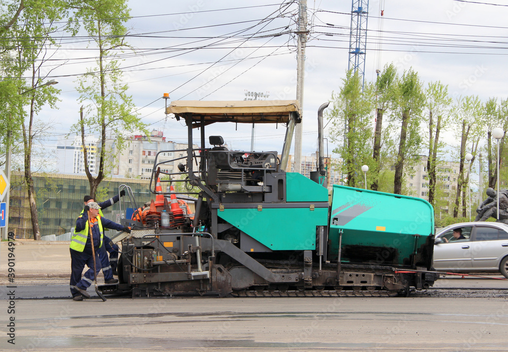 Special road equipment for laying asphalt on the street of the city in Russia. Repair work on the road in the spring