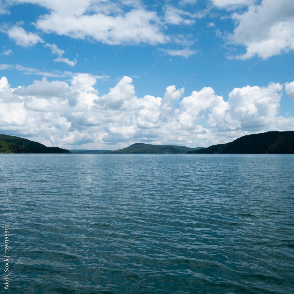 USA, New York, Cooperstown, Otsego Lake, Clouds over lake surrounded by hills