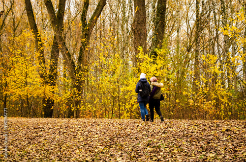Young couple go for a walk in the autumn park © Сергей Семенов