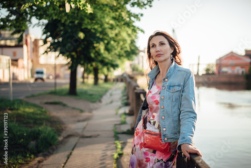 Wallpaper Mural Beautiful aged woman posing on the river embankment. Torontodigital.ca