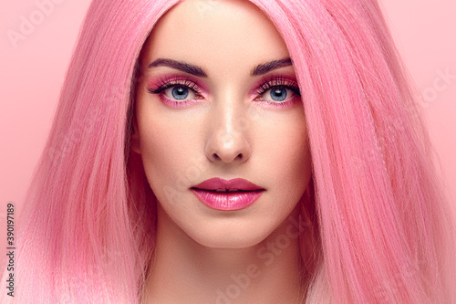 Beauty Fashion woman with Colorful Pink Dyed Hair. Girl with blue eyes, perfect Makeup and Hairstyle. Beautiful smiling model portrait, fashionable pink make up, hair. Skincare concept