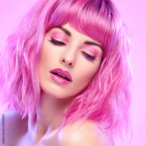 Beauty Fashion woman with Colorful Pink Dyed Hair. Girl with blue eyes  perfect Makeup and Hairstyle. Beautiful smiling model portrait  fashionable pink make up  hair. Skincare concept