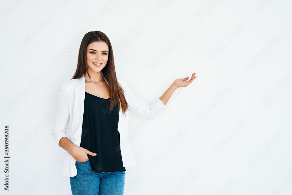 Beautiful smiling woman holding and presenting copy space on her palm isolated on white background