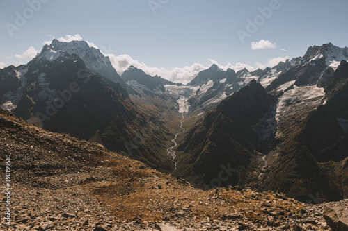 River canyon in mountains. Valley of river and glacier. Beautiful background of Caucasus mountains.