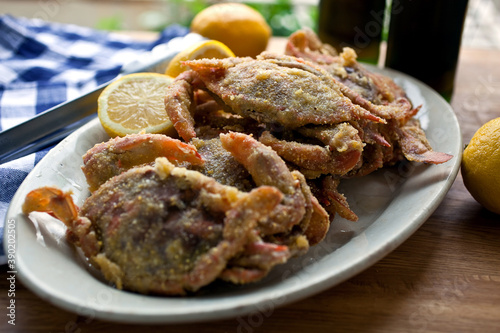 Close up of fried soft shell crab with cornmeal coating served on plate photo