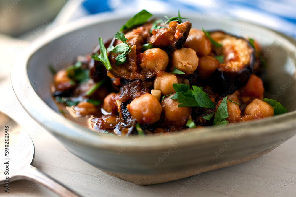 Close up of sweet and sour eggplant, tomatoes and chickpeas served in bowl Close up of sweet and sour eggplant, tomatoes and chickpeas served in bowl