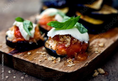 Close up of eggplant parmesan served on cutting board photo