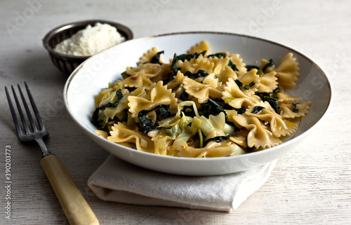 Close up of farfalle with cabbage and black kale served on plate