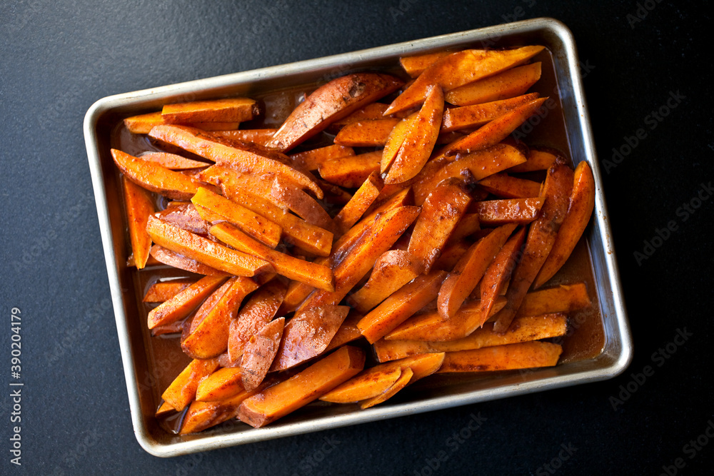 Overhead view of chili sweet potatoes in baking tray Overhead view of chili sweet potatoes in baking tray