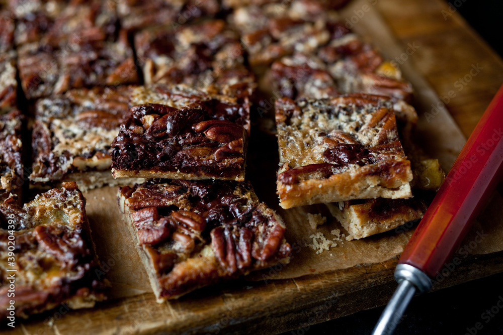 Close up of chocolate pecan bars on cutting board Close up of chocolate pecan bars on cutting board