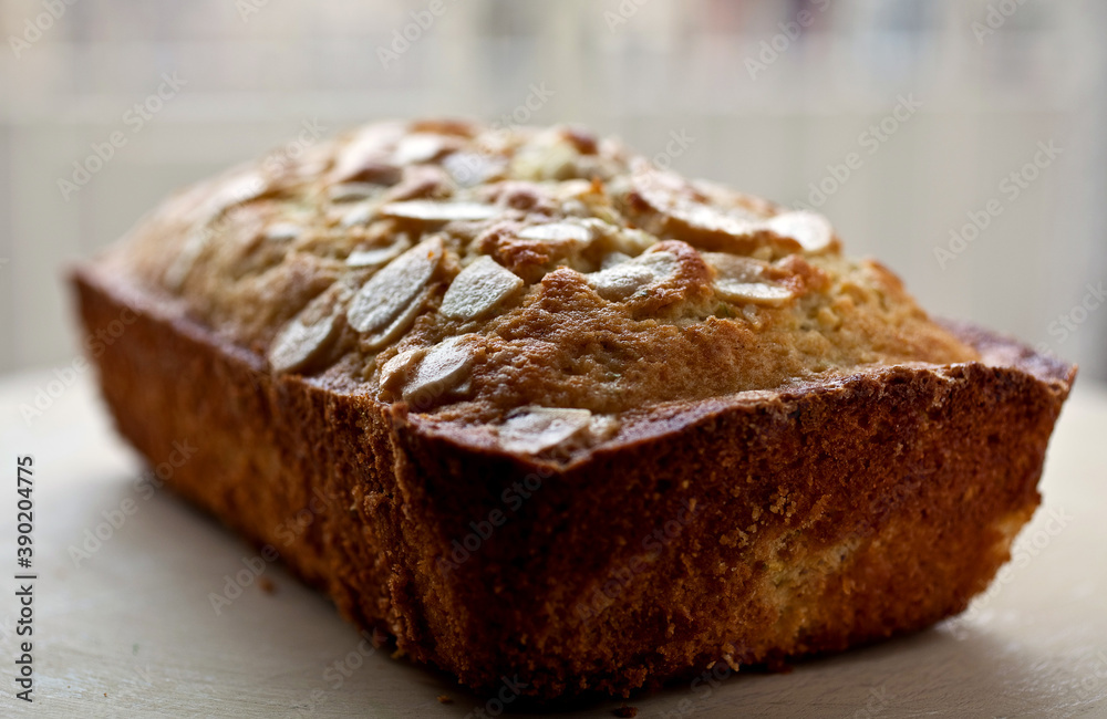 Close up of coconut oil pound cake topped with almonds and lime zest Close up of coconut oil pound cake topped with almonds and lime zest