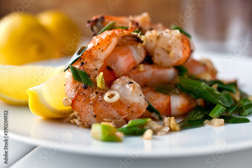 Close up of shrimp sauteed with coconut oil, ginger and coriander served on plate