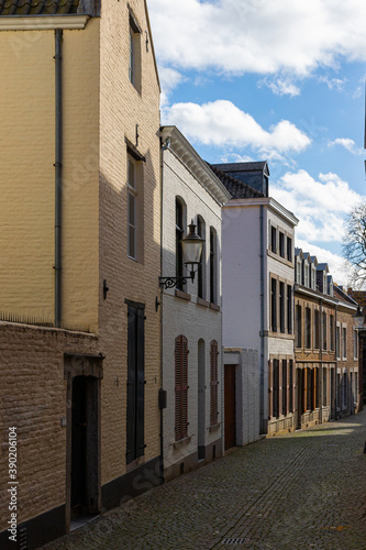 Fototapeta Naklejka Na Ścianę i Meble -  Downtown Maastricht, winding small cobblestone streets with old house which none of them is straight under a dramatic sky.