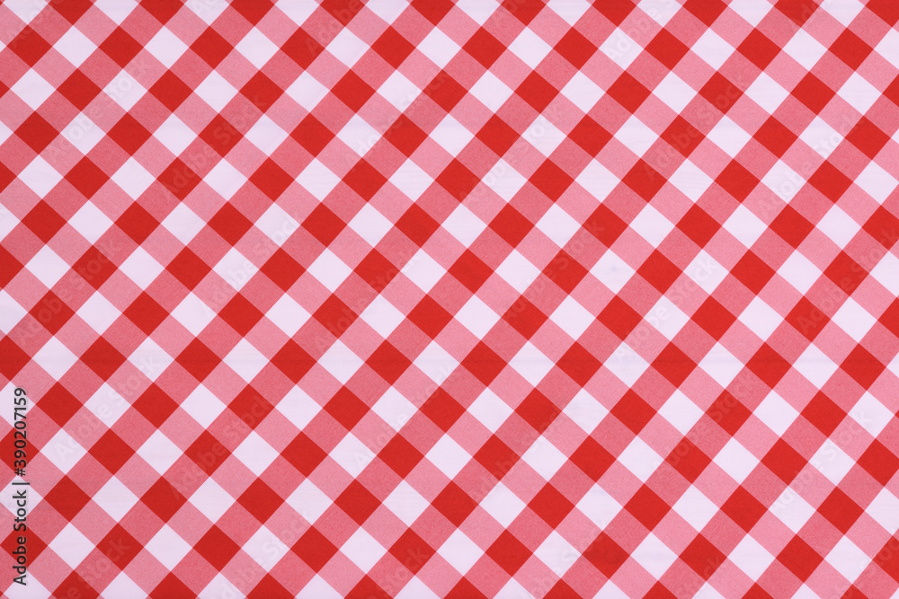 Red checkered textile picnic tablecloth pattern in close-up. Classic italian cuisine style.