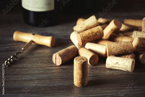 Close-up of a lot of corks from wine bottles and a corkscrew