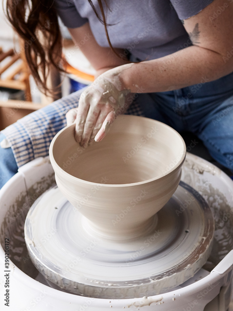 Potter throwing a large bowl on the potters wheel Potter throwing a large bowl on the potters wheel