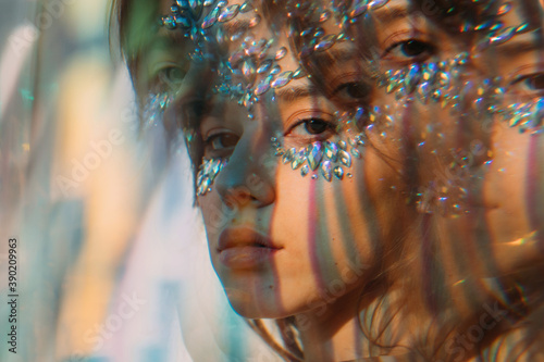 Fotografie Colorful light lines on face of beautiful girl