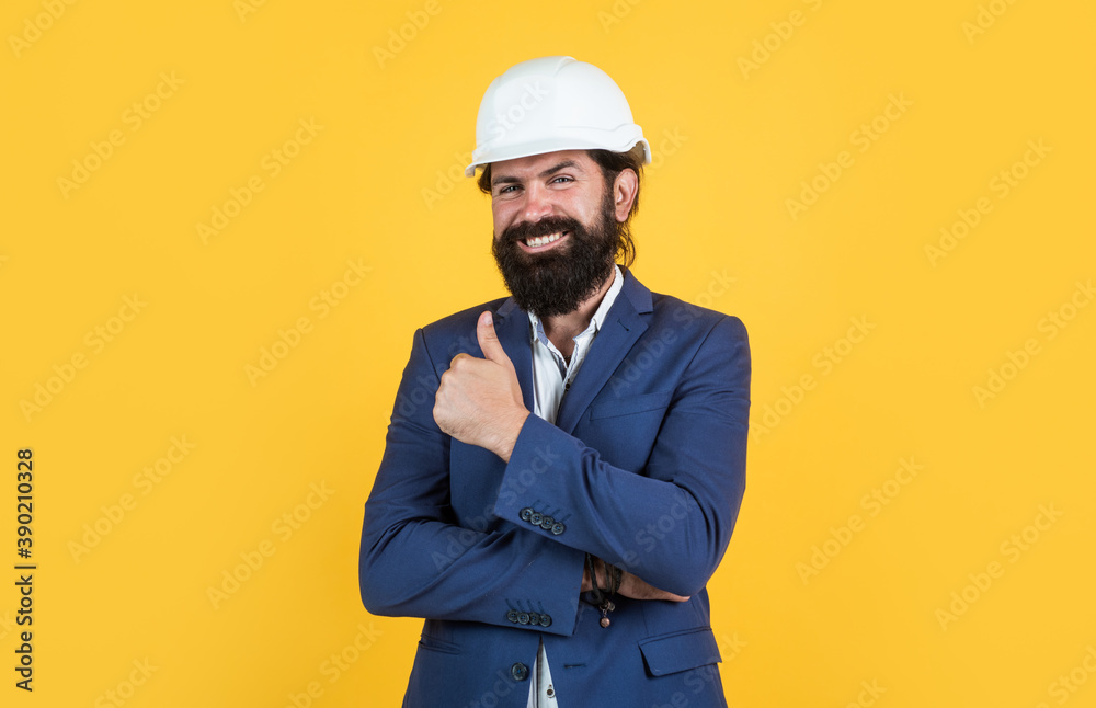 happy mature architect in helmet. brutal bearded man work on construction site. working on project. building concept. builder or engineer in hard hat. showing thumb up. best and success happy mature architect in helmet. brutal bearded man work on construction site. working on project. building concept. builder or engineer in hard hat. showing thumb up. best and success