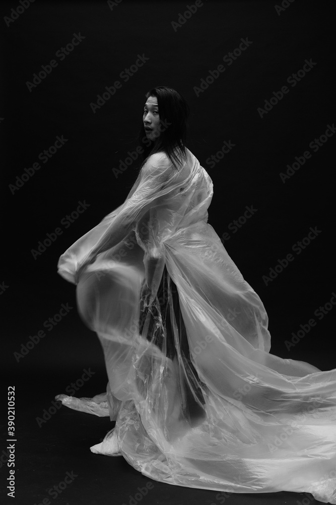 asian long haired man, dressed in plastic. asian long haired man, dressed in plastic.