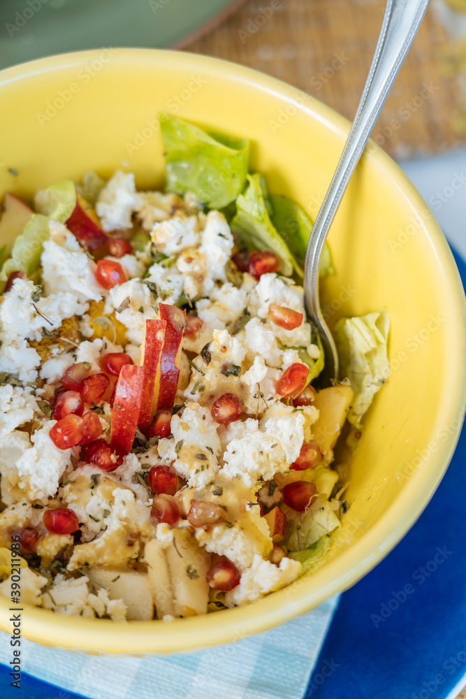 Composition of tasty salad in yellow plate