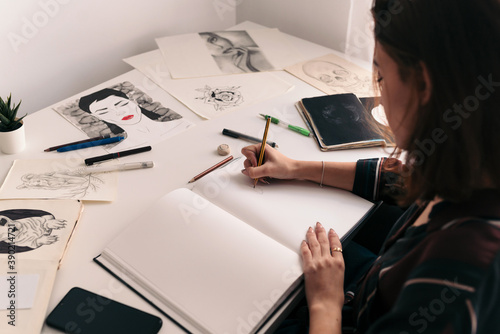 Woman drawing on a notebook photo