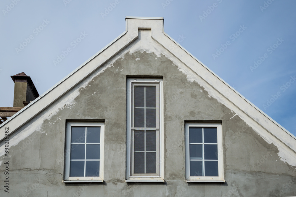 Design of the upper part of the gable of the house with three Windows.