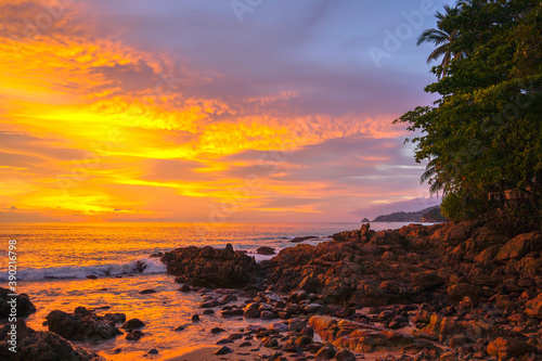 waves hit on the rock at sunset in Kalim beach.Kalim beach is conect to Patong beach there have a lot of reef .and rocks