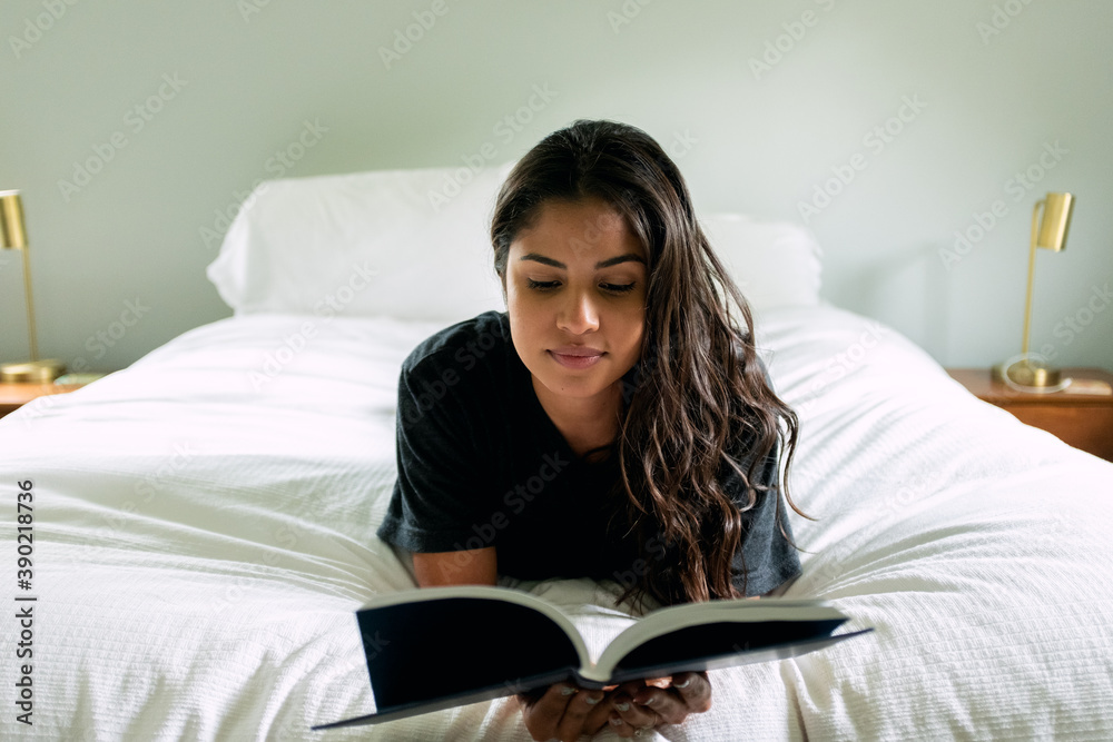 Young woman relaxing in her bedroom Young woman relaxing in her bedroom