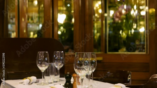 Free table at the restaurant with busy staff in the blurry background
