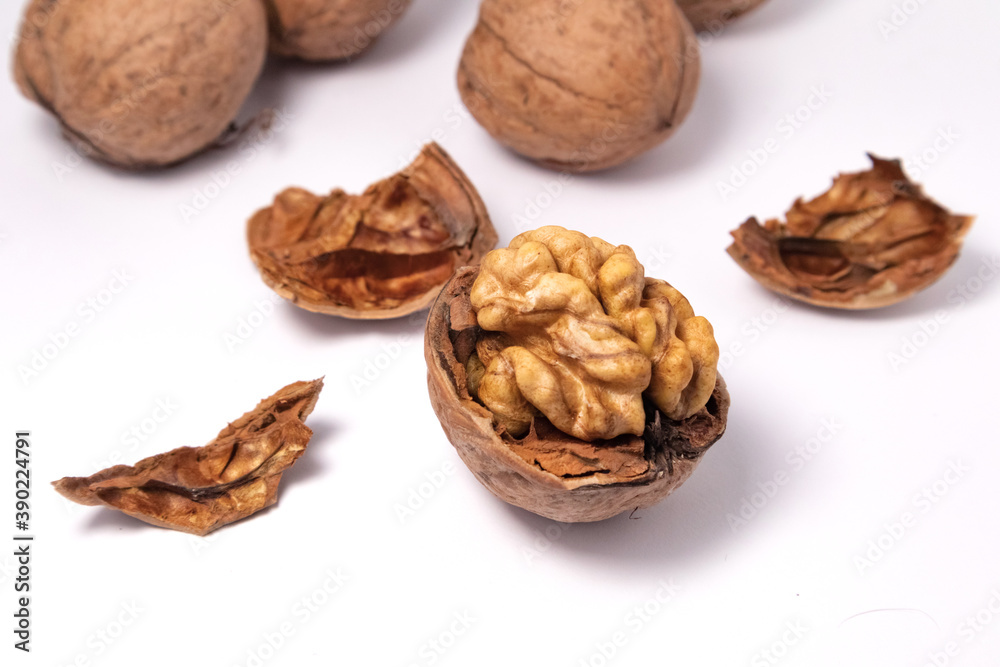 Walnuts isolated on white background. Walnut kernels and whole walnuts Walnuts isolated on white background. Walnut kernels and whole walnuts
