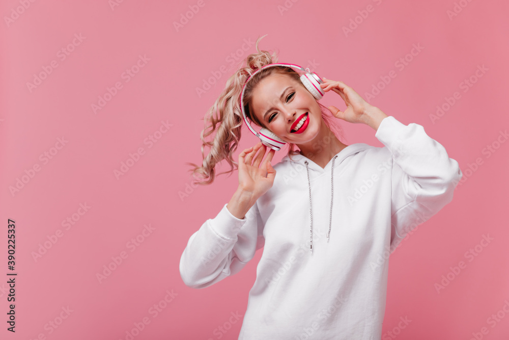 Portrait of happy smiling girl with perfect skin and blush on her cheeks. Student is dancing to her favorite song Portrait of happy smiling girl with perfect skin and blush on her cheeks. Student is dancing to her favorite song