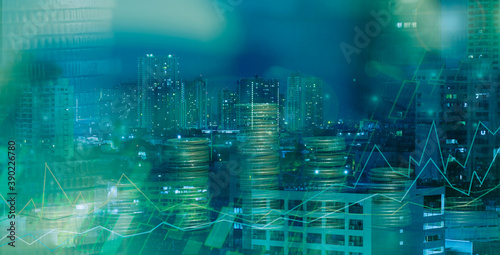 Financial investment concept, Double exposure of city night and stack of coins for finance investor