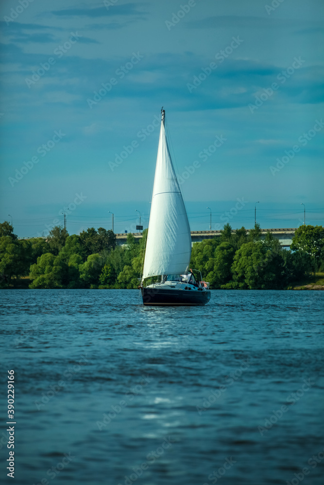 Modern yacht under white sail at Moscow Reservoir