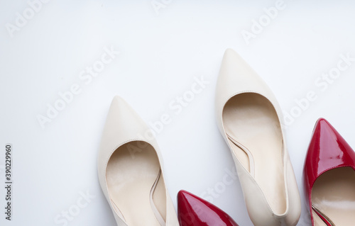 a pair of shoes, beige and red patent leather pumps with heels, on a light background. Fashionable, stylish, women's shoes. Nice shoes, preparation for the holiday, sale, expensive gifts. Diseases of 