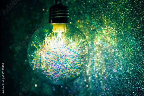 Festive decoration, Christmas and New Year light. Decoration lamp in dark, light bulb decor, copy space. Garlands of burning light in bulb at night