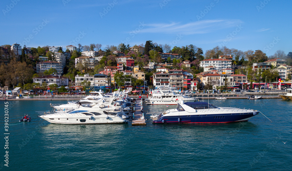 Luxury yachts are parked in Istanbul before the apartments and highway.